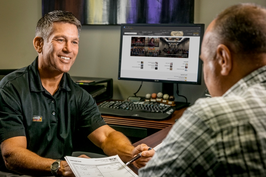 Rush Truck Centers employee sitting at desk with customer