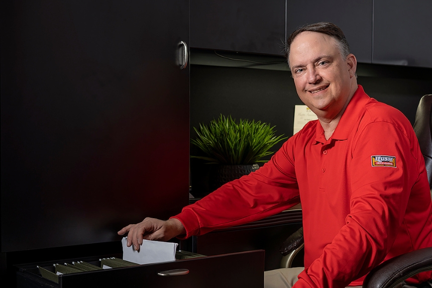 Rush Truck Centers employee taking paper out of filing cabinet